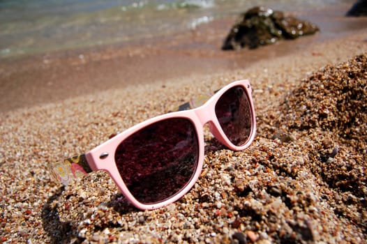 Sunglasses on a sandy beach