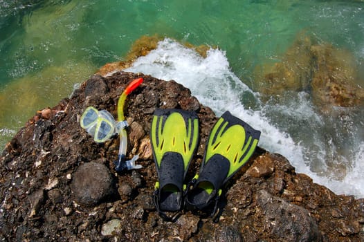 Snorkeling set on a rocky beach