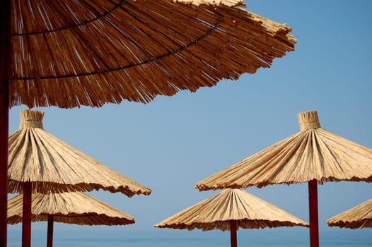 Straw umbrellas on Montenegrin beach