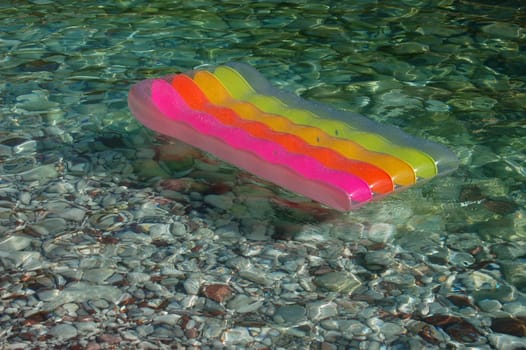 Colored mattress on Adriatic water