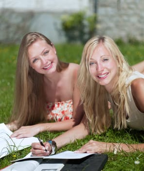two gilrs are learning outside in the park