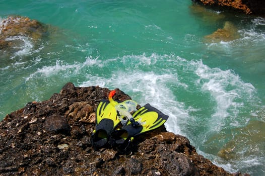 Snorkeling set on a rocky beach