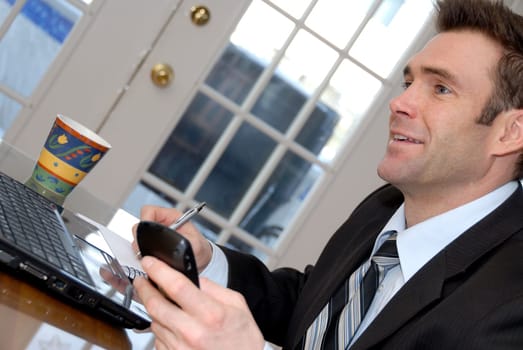 man in a black suit and tie chatting