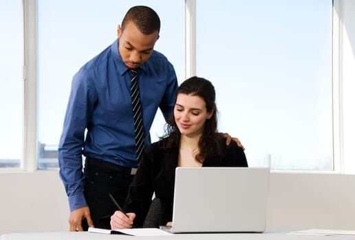 male and female business partners in a window office