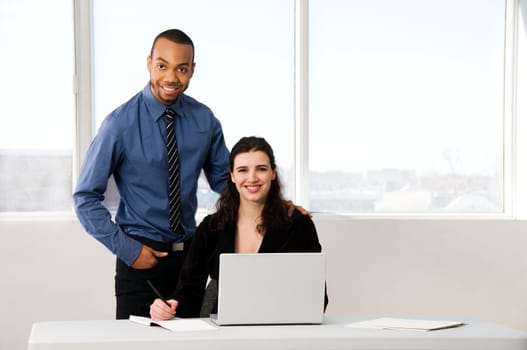male and female business partners in a window office