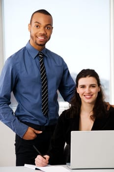 male and female business partners in a window office