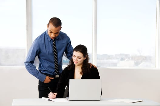 male and female business partners in a window office