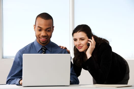 male and female business partners in a window office