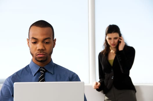 male and female business partners in a window office