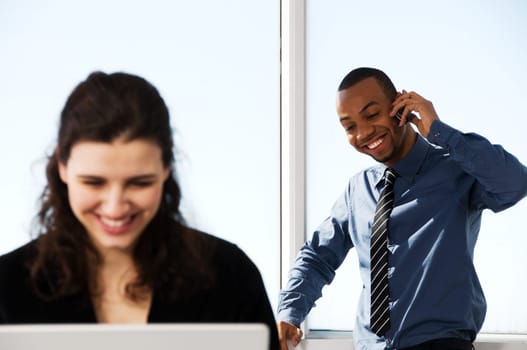 male and female business partners in a window office