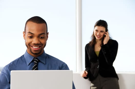 male and female business partners in a window office