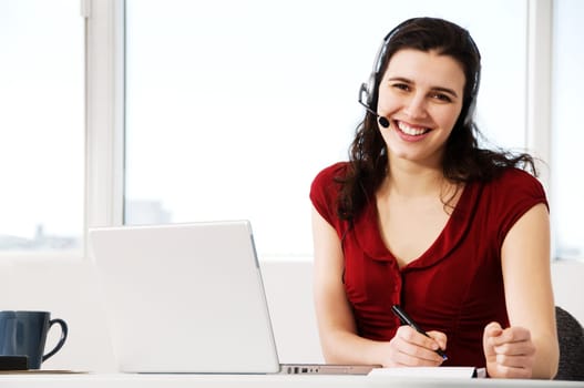 cute woman worker in an office with a headset
