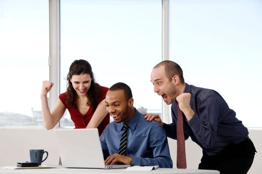 business team in an office on a laptop