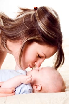 mom and her blue yed baby boy playing around