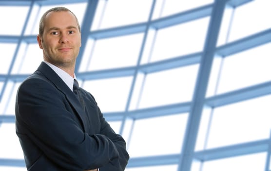 business man with his arms crossed with windows