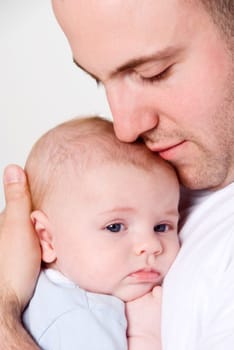 dad holing and caressing his baby boy