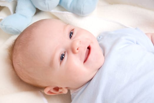 happy smiling baby boy in his crib