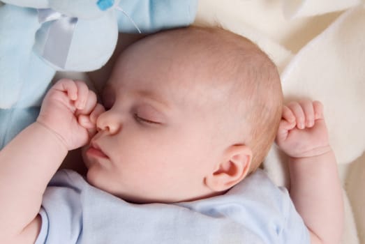 cute baby boy dreaming in his bed