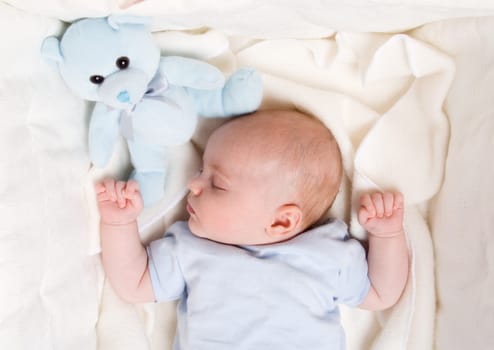 cute baby boy dreaming in his bed