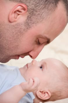 dad playing with his cute baby boy