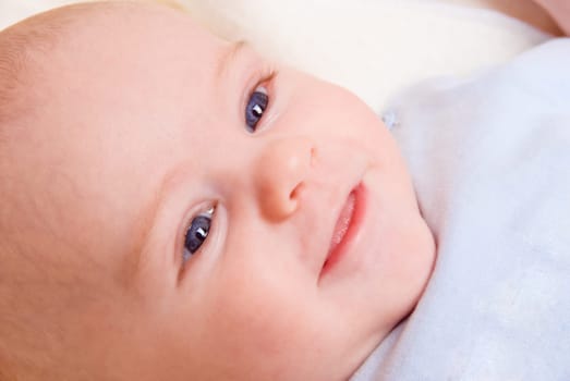 happy smiling baby boy in his crib