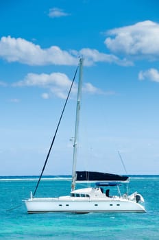 Boat on a blue ocean water with blue sky