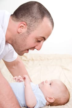 dad playing with his cute baby boy