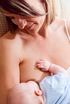 mom breast feeding her hungry baby boy