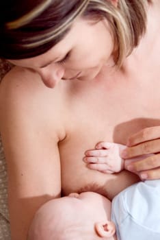 mom breast feeding her hungry baby boy