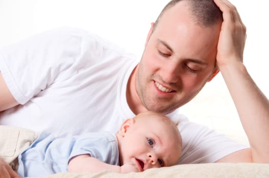dad playing with his cute son in blue