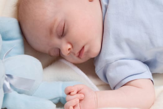 cute baby boy dreaming in his bed