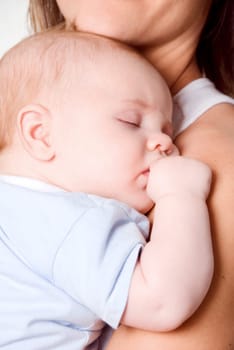 sleeping new born baby boy sucking his thumb