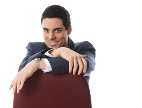 happy businessman sitting on a red chair