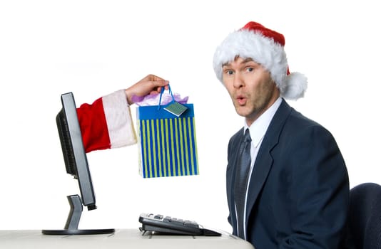 businessman in blue suit with a santa hat surprised
