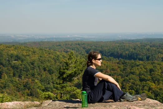 sitting woman on top of a mountain