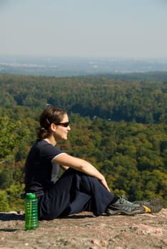 sitting woman on top of a mountain