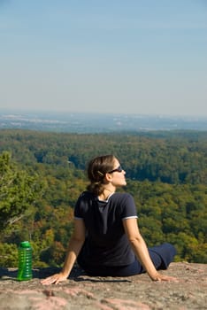 sitting woman on top of a mountain