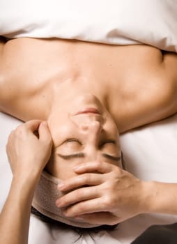woman relaxing with a nice facial massage