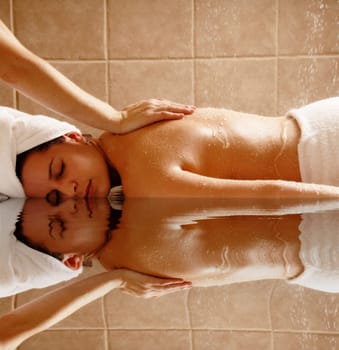 Woman getting a water massage in a day spa