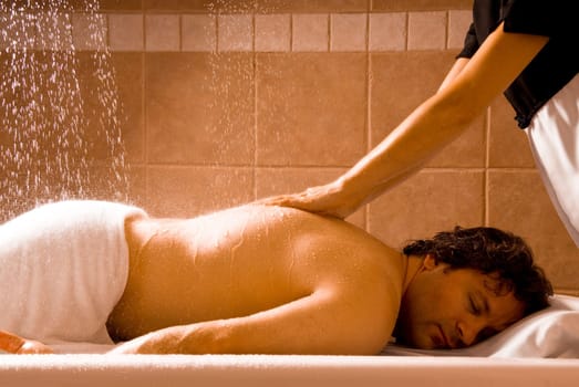 happy relaxing man getting a hydro massage
