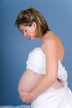 very pregnant woman showing her big belly