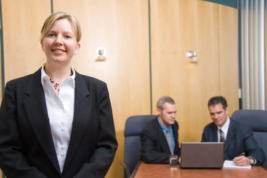 3 business people with woman in foreground
