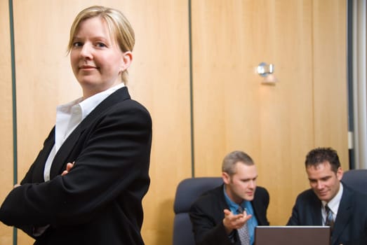 3 business people with woman in foreground