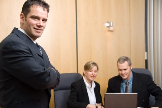 3 business people with man in foreground