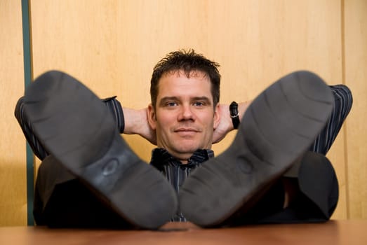 business man with his feet on the desk
