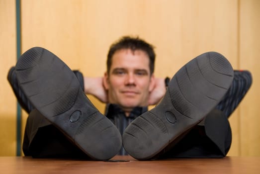 business man with his feet on the desk