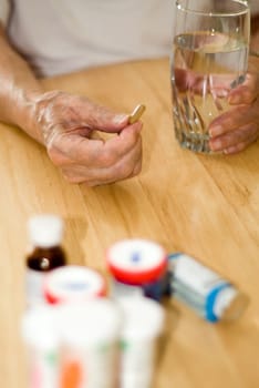 elderly man with all his pills and drugs