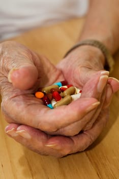 elderly man with all his pills and drugs