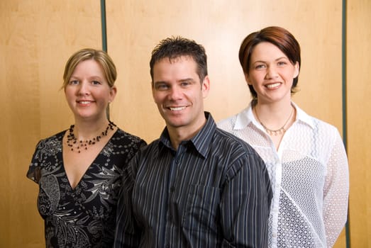 3 business colleagues standing in a meeting room
