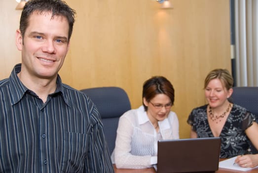 3 business colleagues in a meeting room
